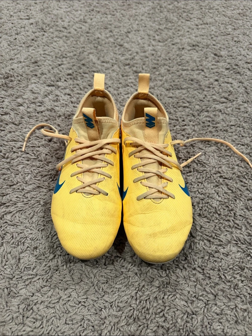 Nike Yellow Soccer Cleats with Blue Swoosh and Orange Accents